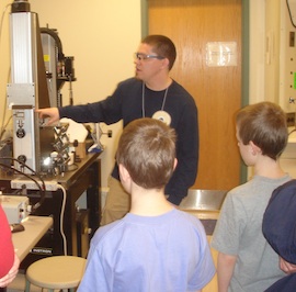 doug showing students how to load a frame